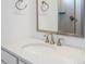 Close-up of a bathroom sink with quartz countertop, modern faucet, and framed mirror at 928 Farrier Ln, Lafayette, CO 80026