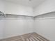 Spacious walk-in closet with shelving and neutral carpet at 928 Farrier Ln, Lafayette, CO 80026