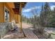 Charming brick patio with outdoor seating, a stairway to the upper level and natural wood siding at 1353 Elk Valley Dr, Evergreen, CO 80439