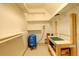 Unfinished basement with shelving, a water pressure tank, and a workbench with a pegboard at 1353 Elk Valley Dr, Evergreen, CO 80439