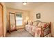 Cozy bedroom with carpeted floor, daybed, natural light, and a full-length mirror at 1353 Elk Valley Dr, Evergreen, CO 80439