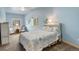 Serene blue bedroom featuring a comfortable bed, two windows, with natural light at 1353 Elk Valley Dr, Evergreen, CO 80439