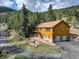Two-story cabin with two-car garage, complimented by landscaped terraced yard at 1353 Elk Valley Dr, Evergreen, CO 80439