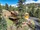 Beautiful mountain home with multiple outdoor areas and a stone-terraced yard at 1353 Elk Valley Dr, Evergreen, CO 80439