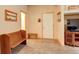 Welcoming foyer with tile floor, wood bench, and a white front door, creating a warm entrance at 1353 Elk Valley Dr, Evergreen, CO 80439