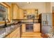 Well-equipped kitchen with stainless steel appliances, granite countertops, and wooden cabinets at 1353 Elk Valley Dr, Evergreen, CO 80439
