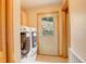 Laundry room featuring modern front loading washer and dryer and access to the outdoors at 1353 Elk Valley Dr, Evergreen, CO 80439