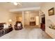 Open-concept living room with carpeted floors, comfortable leather seating, and a vaulted ceiling at 1353 Elk Valley Dr, Evergreen, CO 80439