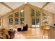 Open floor plan with high ceilings and lots of windows creating a bright and airy living and dining area at 1353 Elk Valley Dr, Evergreen, CO 80439