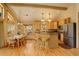 Bright, open living space connecting kitchen, dining, and bar areas with natural light and vaulted ceilings at 1353 Elk Valley Dr, Evergreen, CO 80439