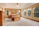 Spacious main bedroom with multiple windows, offering plenty of natural light and scenic views, features carpeted floors at 1353 Elk Valley Dr, Evergreen, CO 80439