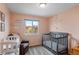 Cozy Bedroom with a crib, changing table, and a comfortable chair at 11402 Benton Ct, Westminster, CO 80020