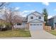 Charming two-story home with a blue exterior, front porch, well-manicured lawn, and an attached two-car garage at 11402 Benton Ct, Westminster, CO 80020
