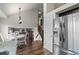 Bright kitchen with stainless steel refrigerator, hardwood floors, breakfast nook, and staircase at 11402 Benton Ct, Westminster, CO 80020