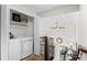Convenient upstairs laundry room with modern appliances and extra storage space at 11402 Benton Ct, Westminster, CO 80020
