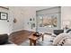 Inviting living room featuring a large window, hardwood floors, neutral wall color and comfortable seating at 11402 Benton Ct, Westminster, CO 80020
