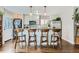 Modern kitchen featuring a breakfast bar with four chairs and stainless steel appliances at 1171 Syracuse St, Denver, CO 80220