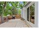 Outdoor patio with grill and view to backyard with mature trees at 4194 S Kalispell St, Aurora, CO 80013