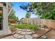 Backyard with large mature trees, rock walkway, and wood fence at 4194 S Kalispell St, Aurora, CO 80013
