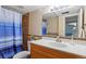 Well-lit bathroom with a shower featuring decorative tile work and a stylish vanity at 4194 S Kalispell St, Aurora, CO 80013
