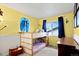 Bright bedroom with bunk beds, a window, and cheerful yellow walls at 4194 S Kalispell St, Aurora, CO 80013