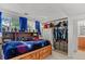 Cozy bedroom featuring built-in shelving, a spacious closet, and ample natural light at 4194 S Kalispell St, Aurora, CO 80013