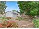 Charming single-Gathering home with a well-manicured front yard, vibrant flower beds, and mature trees at 4194 S Kalispell St, Aurora, CO 80013