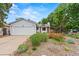 Well-maintained home featuring a lush front yard with vibrant flowerbeds, providing great curb appeal at 4194 S Kalispell St, Aurora, CO 80013