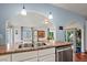 View of the kitchen featuring a stainless steel sink, granite countertops, and an arched doorway at 4194 S Kalispell St, Aurora, CO 80013