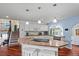 Bright kitchen with white cabinets, stainless appliances, and a center island with seating at 4194 S Kalispell St, Aurora, CO 80013