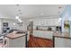 Open kitchen with white cabinetry, stainless steel appliances, and a large island for entertaining at 4194 S Kalispell St, Aurora, CO 80013