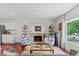 Bright living room features hardwood floors, a cozy fireplace, and ample natural light at 4194 S Kalispell St, Aurora, CO 80013