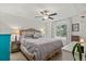 Bright main bedroom with a tray ceiling, ceiling fan, and light hardwood bed frame at 4194 S Kalispell St, Aurora, CO 80013
