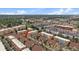 Aerial view of a townhome community, highlighting rooftops, landscaping, and a red arrow indicating a unit at 5465 Zephyr St # 201, Arvada, CO 80002