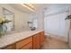 Bright bathroom featuring a long countertop and a shower-tub combo at 5465 Zephyr St # 201, Arvada, CO 80002