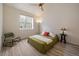 Cozy bedroom features a ceiling fan, big window, and plenty of light at 5465 Zephyr St # 201, Arvada, CO 80002