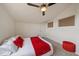 Cozy bedroom with accent lighting, neutral carpet, and a plush white bed with red decorative pillows at 5465 Zephyr St # 201, Arvada, CO 80002