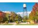 Picturesque community park with trees, a covered seating area, and the iconic 'Olde Town Arvada' water tower at 5465 Zephyr St # 201, Arvada, CO 80002