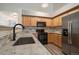Modern kitchen featuring stainless steel appliances and a beautiful backsplash at 5465 Zephyr St # 201, Arvada, CO 80002