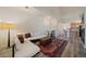 Cozy living room area with bright light, a large sofa, and wood-look flooring at 5465 Zephyr St # 201, Arvada, CO 80002