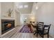 Bright living room featuring a fireplace, wood-look flooring, and dining area at 5465 Zephyr St # 201, Arvada, CO 80002