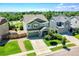 Aerial view of a home with a well-manicured lawn, driveway, and mature trees at 428 Starline Ave, Lafayette, CO 80026