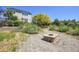 The backyard has a stone fire pit surrounded by lush landscaping at 428 Starline Ave, Lafayette, CO 80026