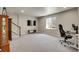 Spacious finished basement with a large window, tv, carpet and adjacent staircase at 428 Starline Ave, Lafayette, CO 80026