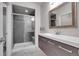 Modern bathroom featuring a sleek vanity, and a glass-enclosed shower with stylish tile at 428 Starline Ave, Lafayette, CO 80026