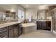 Elegant bathroom features dual vanities, a soaking tub, tiled backsplash, and modern fixtures at 428 Starline Ave, Lafayette, CO 80026