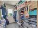 Walk-in closet with shelving and clothing storage racks, plus a window to provide natural light at 428 Starline Ave, Lafayette, CO 80026
