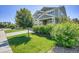 Expansive front yard showcasing lush green grass and mature landscaping, complementing the home's exterior at 428 Starline Ave, Lafayette, CO 80026