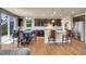 Expansive kitchen with a large island, bar stool seating, and stainless steel appliances adjoining a dining area at 428 Starline Ave, Lafayette, CO 80026