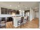 Beautiful kitchen featuring a central island, stainless steel appliances, and dark cabinets, combining style and functionality at 428 Starline Ave, Lafayette, CO 80026